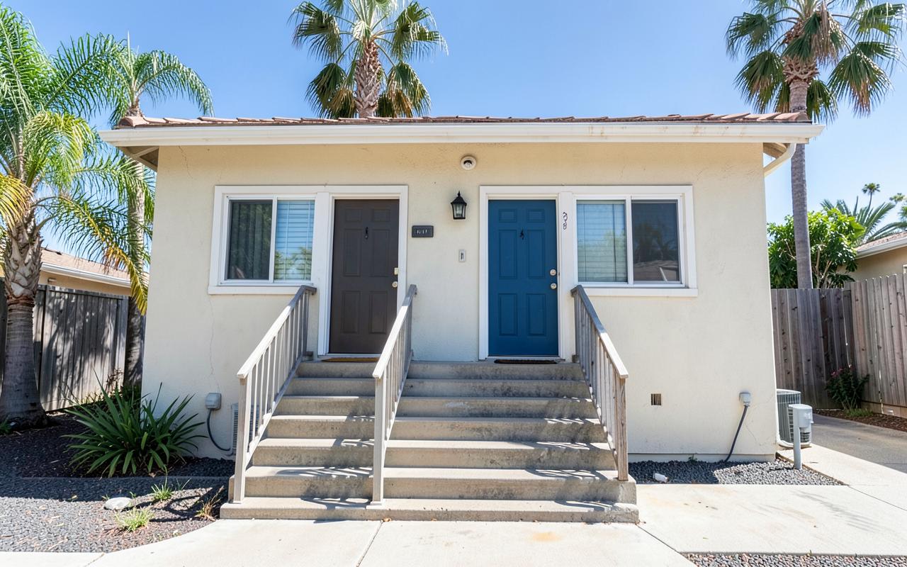 Small Southern California duplex with two front doors in afternoon sunlight, representing rental property ownership